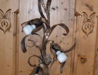 Wall-mounted lighting fixtures hand-crafted in iron