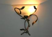 Wall-mounted lighting fixtures in wrought iron with glass