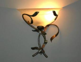 Wall-mounted lighting fixtures in wrought iron with glass