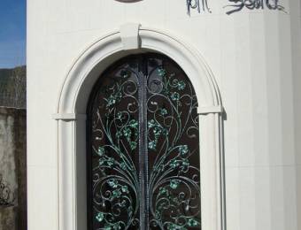 Wrought iron door with green decorations
