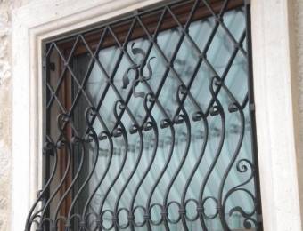 hammered hand made wrought iron window protection with decorations