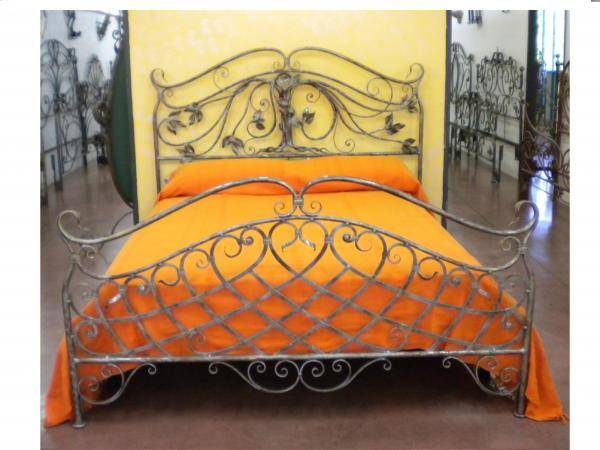 Forged wrought iron bed with tree sculpture on the headboard
