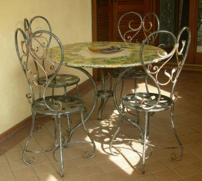 Wrought iron chairs with table