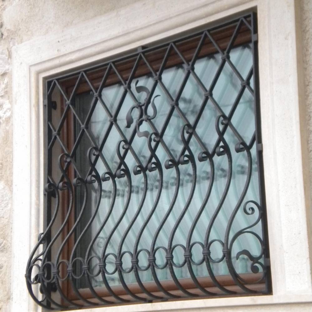 hammered hand made wrought iron window protection with decorations