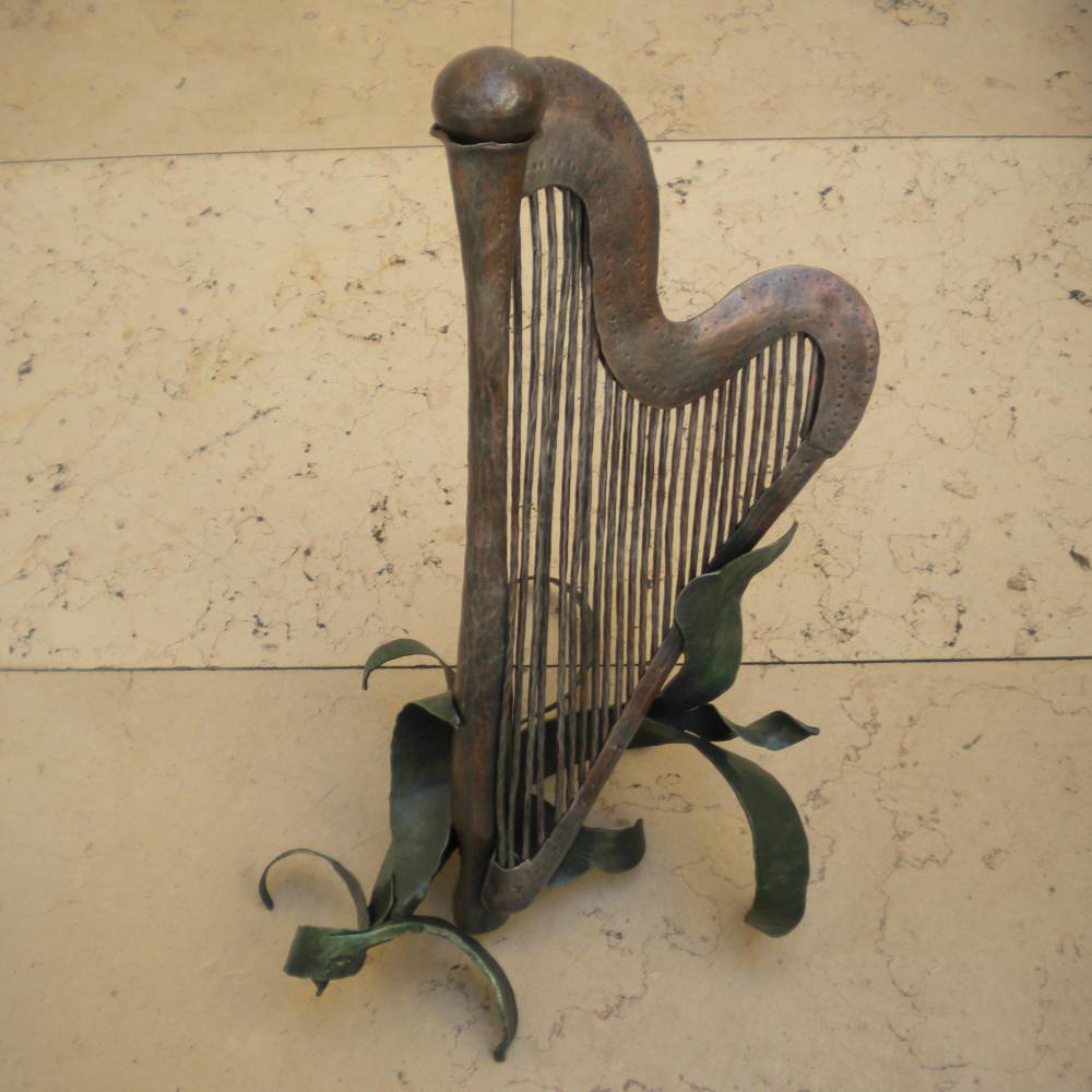 wrought iron sculpture representin a harp